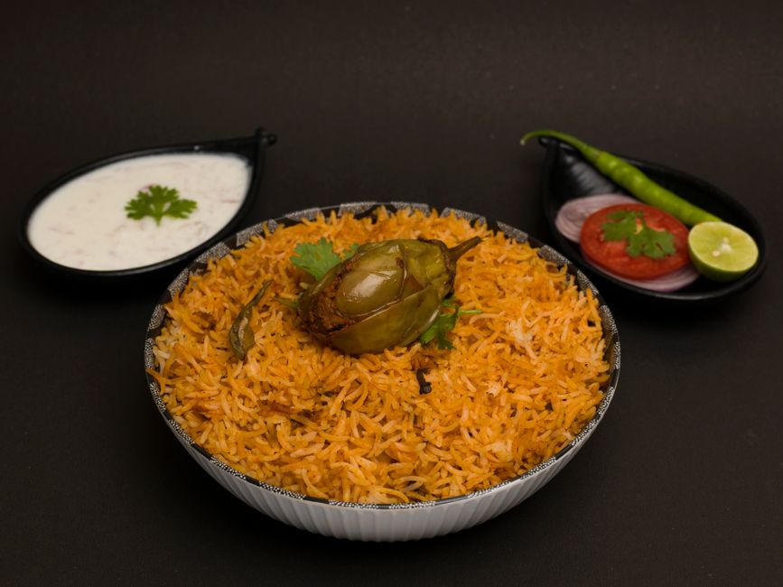 Close-up of a plated Hyderabadi biryani with saffron rice